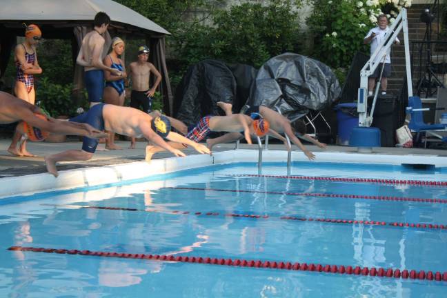 Boys age 11-12 dive in for the 50M breast stroke against Mountain Lakes last Wednesday at Lake Mohawk Pool.