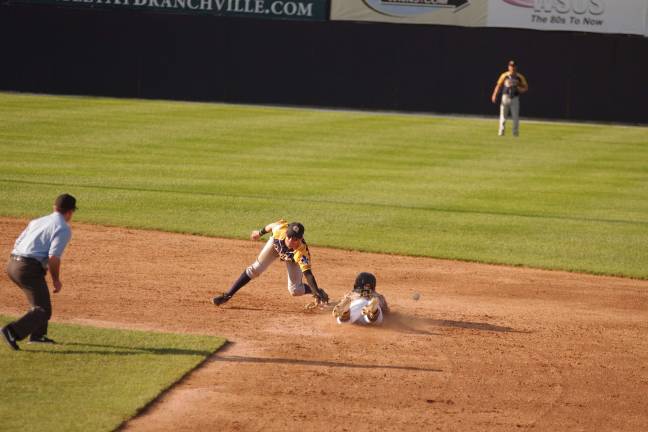 The thrown ball gets past infielder Nick Gotta as Sussex County Miners runner Mikey Reynolds slides safely into second base in the eighth inning.