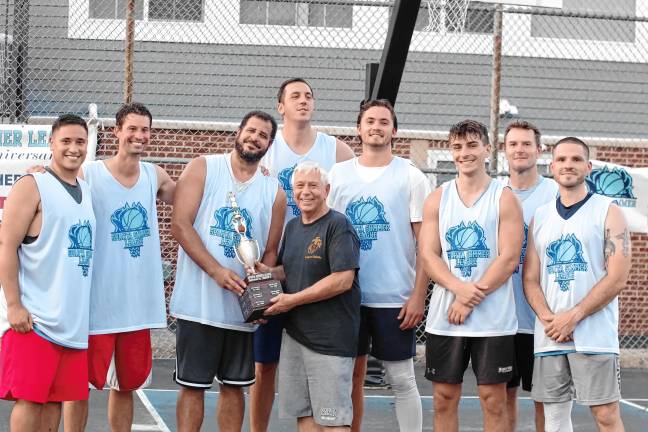 SB3 Sparta Summer Basketball League organizer Charlie Collver poses with Team Smalley and the championship trophy. Team Smalley players are Jamie McKenna, Colby Thompson, John Smalley, Almin Hodzic, Steven Breeman, Matt Moran, Jason Dobbs and Nick Miller.