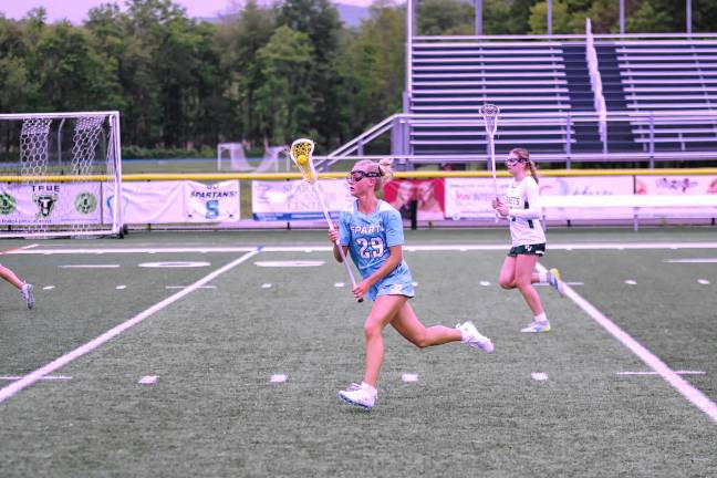 Sparta's Grace Johnson carries the ball with her crosse. She scored two goals and made one assist.