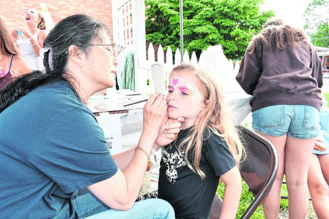 Remington Washer of Sparta gets her face painted.