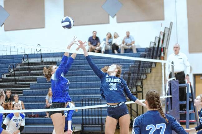 Sparta's Brooke Meara (31) knocks the ball over the net.