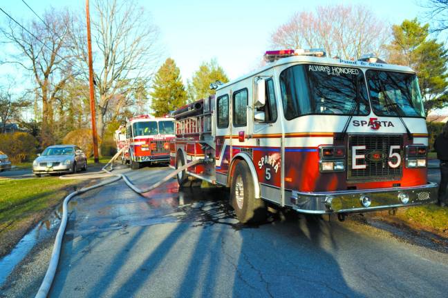 Sparta Township Fire Department trucks pump water to firefighters fighting a structure fire on Birch Tree Lane. Firefighters from the Ogdensburg Fire Department assisted in getting the fire under control. No damage was sustained by any neighboring homes. Sparta Township Police Department Photograph