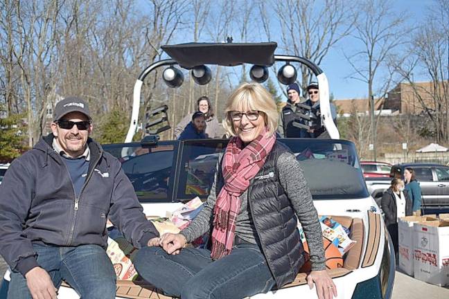 Lou and Sherri Cecchini and their staff members at Off Shore Marine in Branchville arrive Dec. 14 with a boatload of toys for Project Self-Sufficiency in Newton. The great room at the nonprofit is transformed into a toy shop each holiday season so those less fortunate can pick out toys for their children.