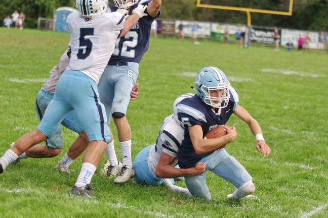 Sparta quarterback Kenny Oelkers is taken down in the second half. Oelkers scored one rushing touchdown.