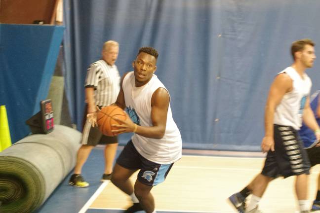 Team Tobin's Trey Smith handles the ball on the court. Smith is a graduate of Sparta High School.