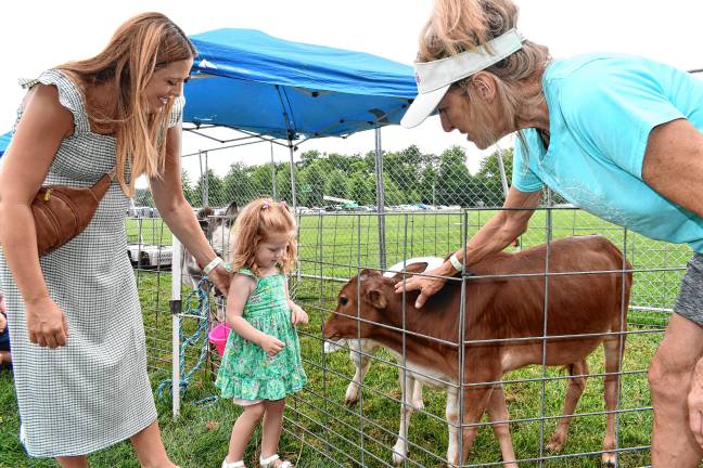 Layla Murphy of Sparta checks out the animals in the petting zoo during the Sparta Food Truck &amp; Music Fest on Saturday, July 19. (Photos by Maria Kovic)