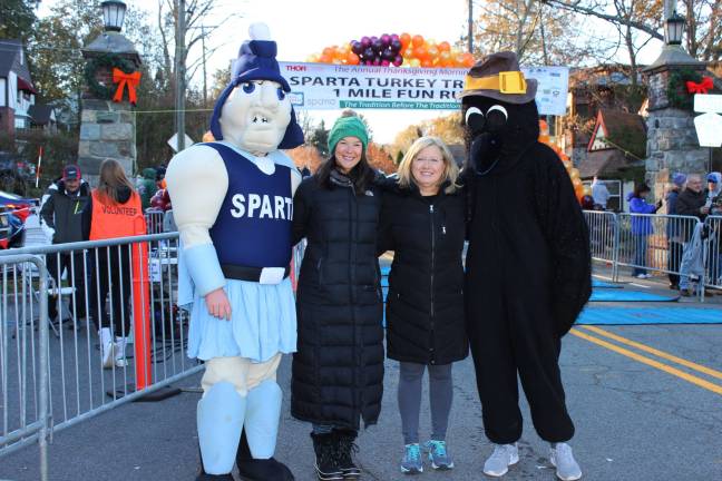 Between mascots are Turkey Trot co-chairs Kylen Anderson, left, a member of the Sparta Board of Education, and Dorothey LeBeau, SEF past president Photo courtesy of SEF