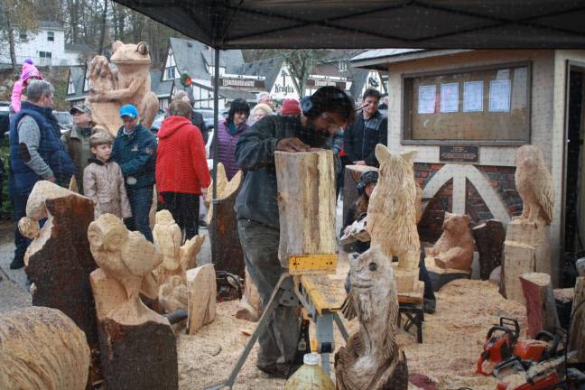 Wood carving from Freehand Custom Carvings in Newton entertains the large crowd.