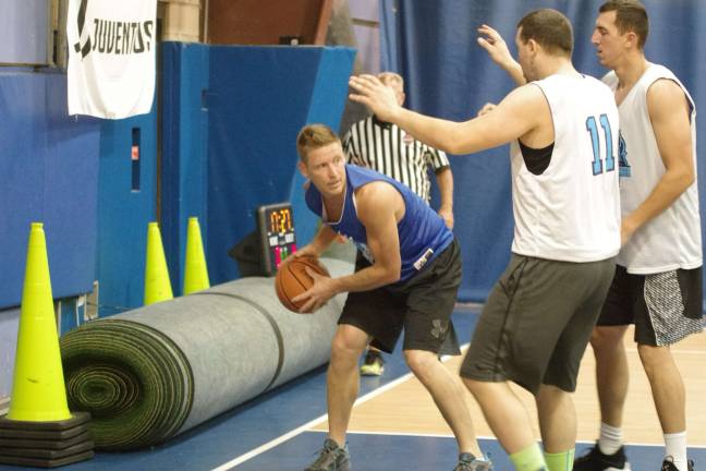 Team Synol's Josh Funk holds the ball under double coverage in the first half.