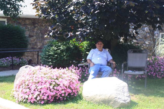 Russell McCarrick smiles on the flowers and on passers-by