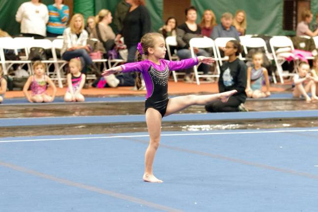Six year old Nina Scaffidi of Hammonton, New Jersey executes a pose during a floor routine. Scaffidi has been involved in gymnastics since the age of three and is a member of Flyers Gymnastics located in Atlantic County, New Jersey.
