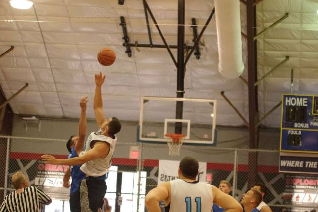 The tip-off between Team Synol's Brandon Zaleski and Team Tobin's Almin Hodzic starts the contest.