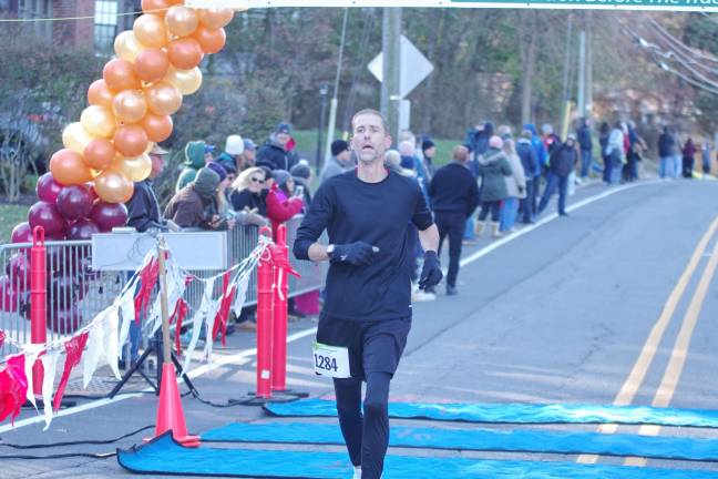 Fifty two year old Lee Toussaint of Milford, Pennsylvania crosses the 5K finish line with a time of 18:58.5. Toussaint finished 15th.