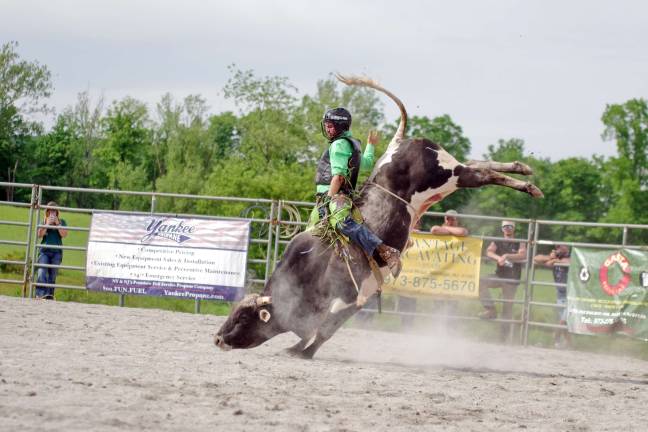 A raging bull tries to shake off a rider.