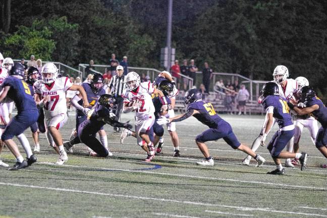 <b>Whippany Park ball carrier Nick Casale runs through an opening in the Jefferson defense in the first half. He made it to the end zone for a touchdown. The extra point kick tied the score, 14-14, in the second quarter.</b>