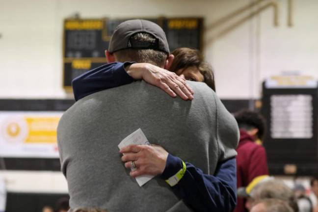 The agony of defeat: a Spartan wrestler consoles the mom of his teammate who just lost his match, eliminating his spot at the States Championships.