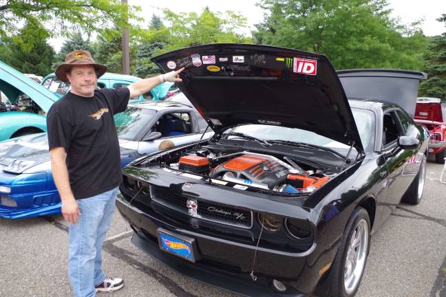 Blair Debois of West Milford, New Jersey points to some of the celebrity autographs on his customized 2010 Dodge Challenger R/T. Photos by George leroy Hunter