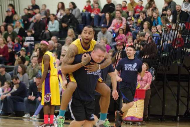 Harlem Wizard Timothy "Tomahawk" Stukes hitches a ride on an opposing player.