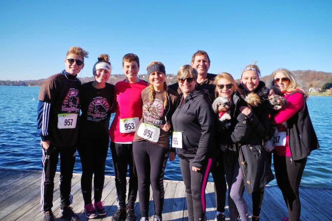 With Lake Mohawk as a backdrop the O'Brien family and their dogs of Sussex County, New Jersey pose for a post run portrait. From left are Timothy, Olivia, Jonathan, Alexandra, Susan, Terence, Victoria, Elizabeth and &quot;Aunt&quot; Judy Soltis.