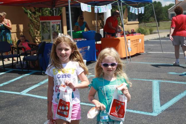 Mallory and Mackenzie Gass leaving with goody bags.