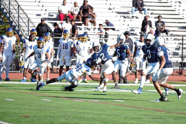 <b>Sussex Skylanders ball carrier Jabron Solomon swerves in an attempt to avoid a Monroe University defender in the season-opener Aug. 30. SCCC lost, 28-6. (Photos by George Leroy Hunter)</b>