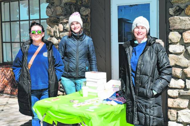 Ashley Storms, Victoria Piszczek and Janine Saba, members of the Sparta Volunteer Fire Department Ladies Auxiliary, sell cookies at the event.