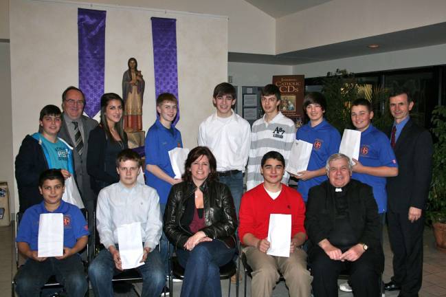 Seated, from left: John Hunter Zoetjes, team co-captain Ed Weaver, Julie Schuldner Executive Director of Interfaith, team co-captain Ben Insley, and Father Patrick Rice pastor of Blessed Kateri. Standing, from left: Hunter Roggero, Knights District Deputy Charlie Farrie, Squire Rose Cassandra Zoetjes, Daniel Smith, Danny Lubertazzi, Raymond Roggero, Michael Dolecki, Matthew Dolecki, and Grand Knight Nick Cutrone.