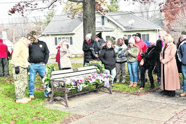 Flowers were laid on a bench.