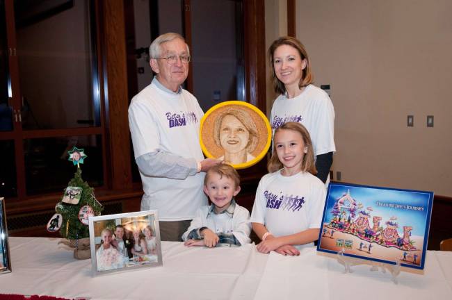 PHOTOS BY LAURIE GORDON The family of Betsey Niles, a mother who died after being struck by a van in March 2011, honored her legacy with a &#x201c;floragraph&#x201d; on the Donate Life Rose Parade Float in Pasadena, California, on New Year&#x2019;s Day. Her partner of 10 years, Dan Sarnowski, of Sparta, (left) holds the floragraph and is the chair of this weekend's annual NJ Sharing Network's Celebration of Life 5k.