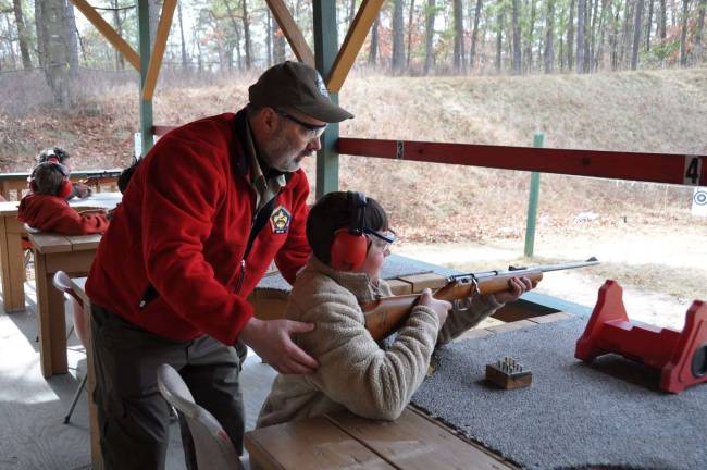 New Scout Hunter Roggero assisted by Scoutmaster Joe Fucito.