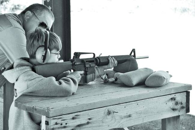 Photographs were provided by Troop Photo Historian Raymond Roggero, a 14 year old Life Scout. Star Scout Ben Toscano shooting an AR-15 rifle.