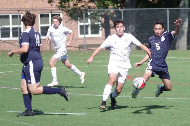 Pope John's Jakob Makeover kicks the ball late in the game.