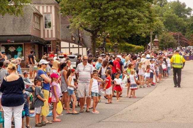 Spectators line the street awaiting the parade