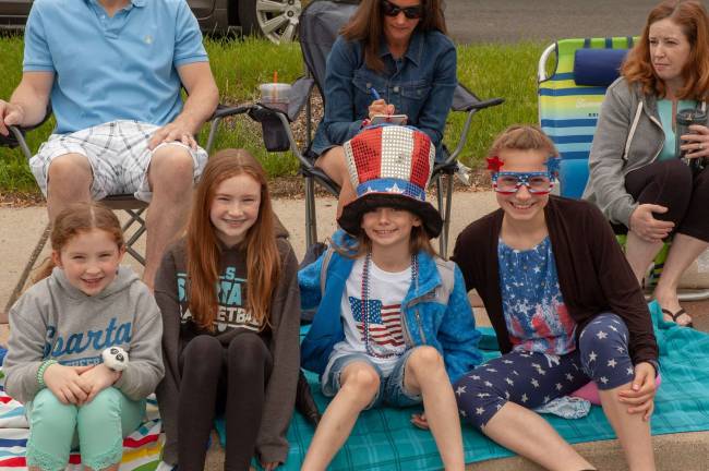 Elizabeth O'Brien, 7; Kayleigh O'Brien,11; Ava Picinic, 10; Alena Picinic, 12; all of Sparta, watching the parade