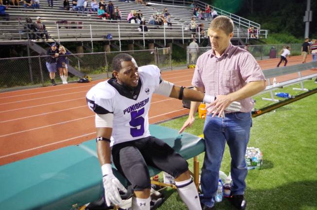 Nassau Punishers safety Durrel Bradley is tended to by physical therapist Terence Moran of West Milford Physical Therapy and Fitness (Passaic County, N.J.) to address some soreness.