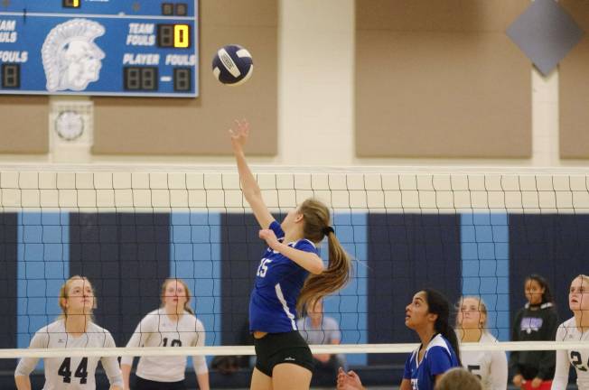 Warren Hills' Elizabeth Lea taps the ball over the net in the second match. Lea accomplished two service points, one kill, two blocks and twenty digs.