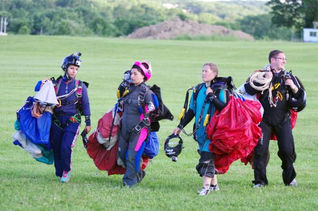 From left, skydivers Dalia Salloum, Christine Shirinian, Sara Mueller and Steve Villardi carry their gear after landing.