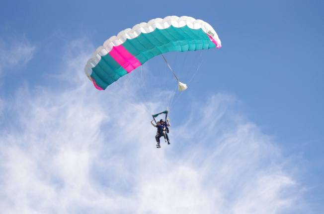 Coming back down to earth Irene Chu of Queens, New York experiences her first jump with a skydive instructor. Photos by George Leroy Hunter