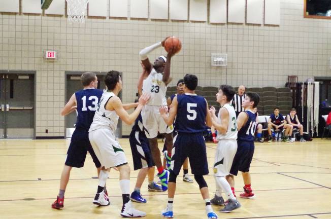 Veritas Lion Tolu Akintunde with the ball leaps towards the hoop. Akintunde scored ten points.