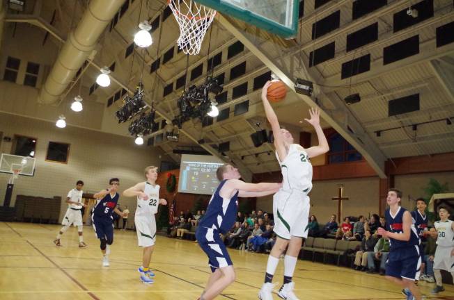 Veritas Christian's Matthew Barber grabs a rebound. Barber scored eighteen points and grabbed four rebounds.