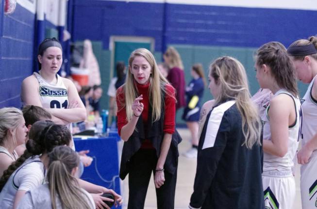 Kaitlyn Gaffney (center) is the Head Coach of the Sussex County Community College women's Basketball Program. Gaffney is seen here talking to her players during a timeout.