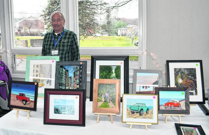 Bob Wiberton of Branchville stands behind photos.