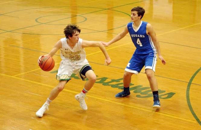 Sussex Tech's Zachary Clawson handles the ball while covered by Kittatinny's Justin Dube in the second period.