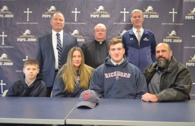 Pope John XXIII Regional High School senior defensive lineman Louis Montana signed to play football at the University of Richmond. Seated next to Montana, from left, are Montana's brother, Matero, Montana's mother, Jannie, and Montana's father, Louis. Standing in back are Pope John Principal Gene Emering, Pope John President Rev. Msgr. Kieran McHugh, and Pope John head coach Brian Carlson.