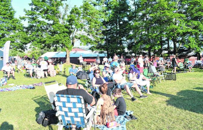 <b>Festival attendees wait for the performance to start.</b>