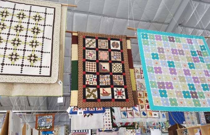 Colorful quilts draw the eye upward as they hang from the ceiling of the Richards Building.