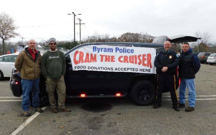 (L-R) Byram Township Manager Joe Sabatini, Mayor Alex Rubenstein, Police Chief Pete Zabita, and Ptl. Robert Schellhammer encouraged Byram residents to cram the cruiser to support Stuff the Bus 2018, on Sunday, Nov. 18, 2018 at the Byram ShopRite Plaza. 