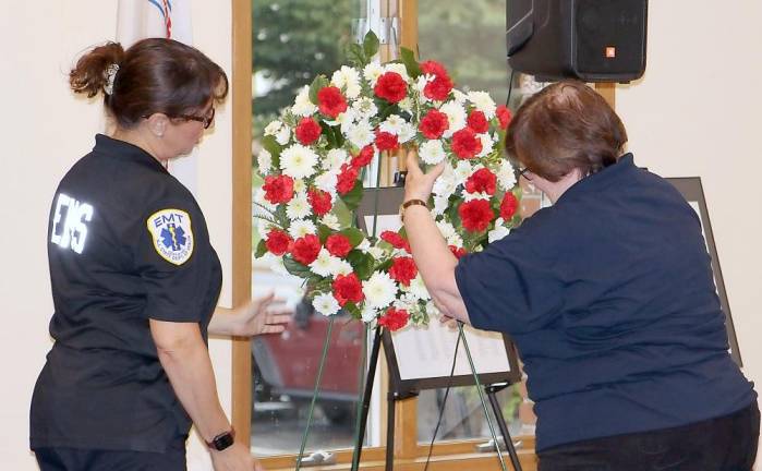 Miriam Ungar and Janice Johnson place a memorial wreath (Photo provided)