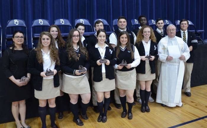 Twelve Pope John XXIII Regional High School seniors and two faculty members pose for a picture after receiving service awards during the 2018 Service Awards Liturgy on Wednesday at Pope John in Sparta. First row, from left, are: Katie Valenza, Toni Ippolito, Victoria Caruso, Adriana Purcell, Grace Campbell and Pope John President and Principal Rev. Msgr. Kieran McHugh. Second row: Mrs. Fabiana Lynch, Grayson Smetana, Margaret Butler, Trevor Potts, Nick Bello, Peacemaker Bakinahe, Jordan Paladini and Robert Kerwick.